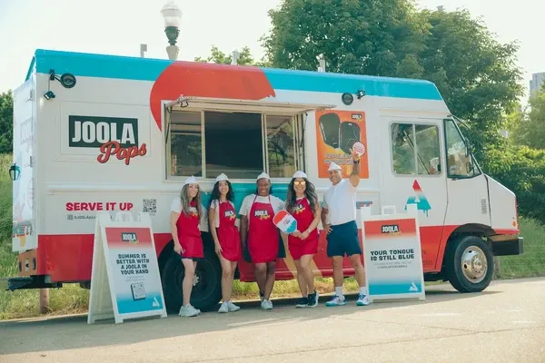 PPA Tour ice cream truck with staff and promotional signs.
